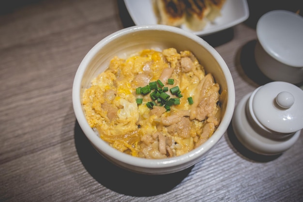 Japanes food gyudon or butadon with egg lunch meal on wood table