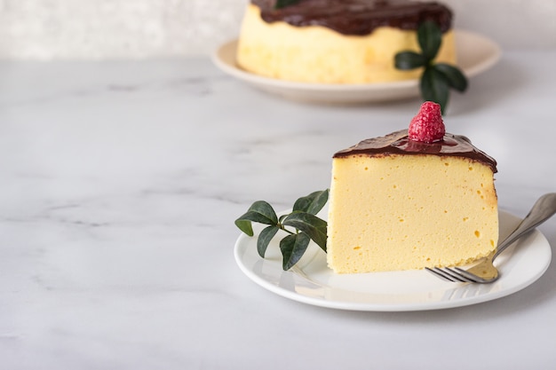 Japanese cotton souffle cheesecake decorated with chocolate glaze on ceramic plate