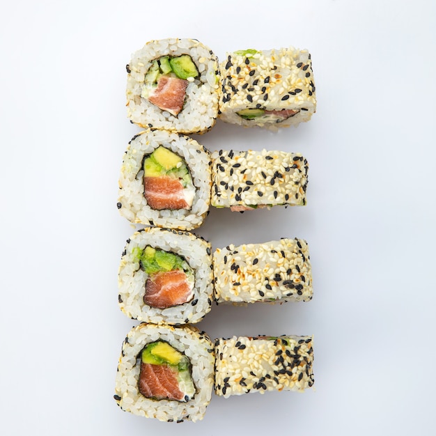 Japanese cuisine. Sushi roll on white background. Top view