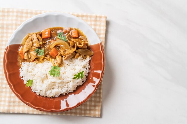 Japanese curry rice with sliced pork, carrot and onions