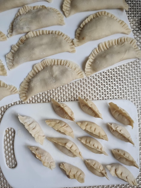 Japanese dumplings and raw dumplings on the table in the kitchen