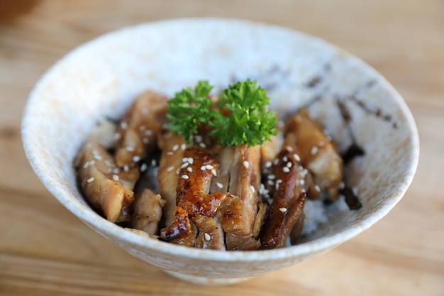 Japanese food , Chicken teriyaki with rice on wood background