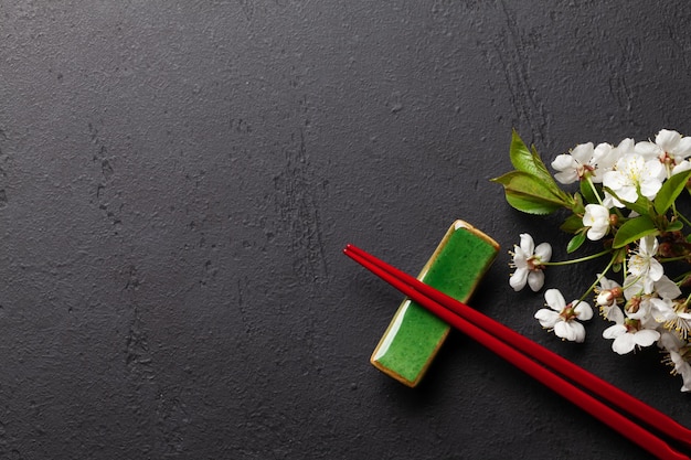 Japanese food with cherry blossom and sushi chopsticks