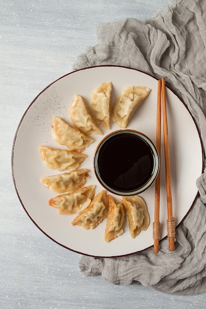 Japanese Gyoza dumplingsfried with sauce top view without people tinted selective focus