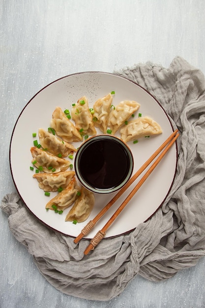 Japanese Gyoza dumplingsfried with sauce top view without people tinted selective focus