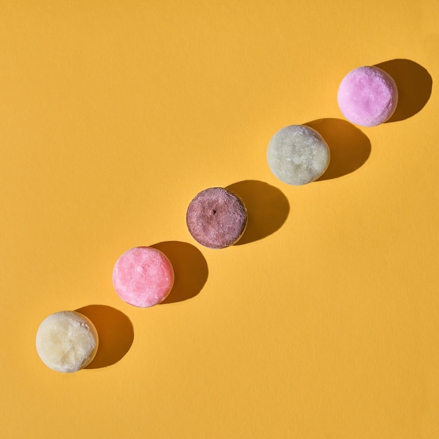 Japanese ice cream Mochi in rice dough. Traditional Japanese dessert on a yellow background. Concept