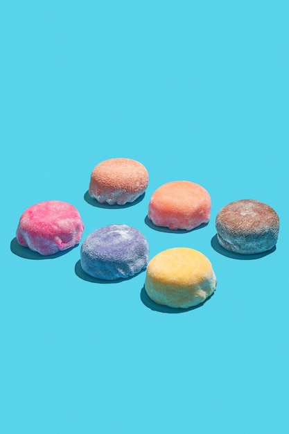 Japanese mochi desserts with different flavors Multicolored mochi pattern on a blue background