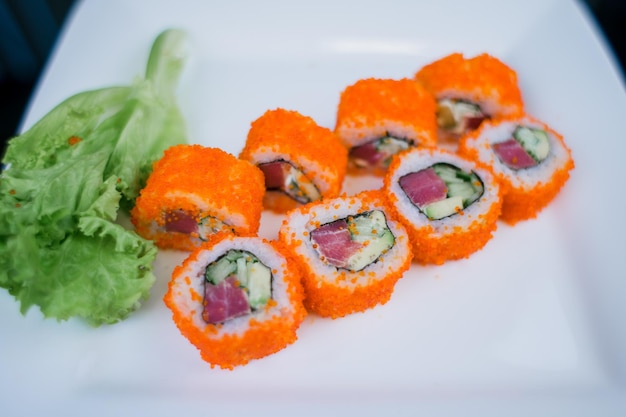 A Japanese roll with tuna and white rice in tobiko caviar