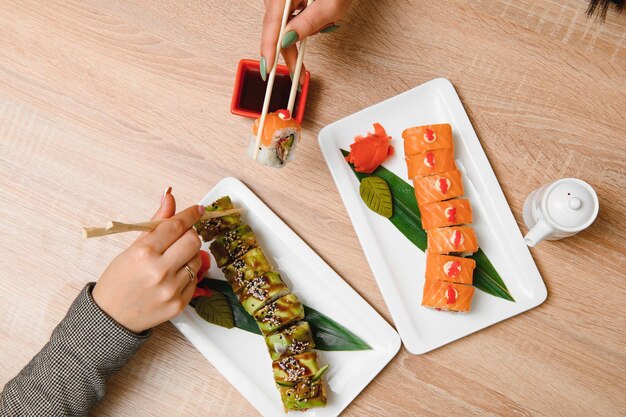 Japanese rolls on black background isolated with reflections