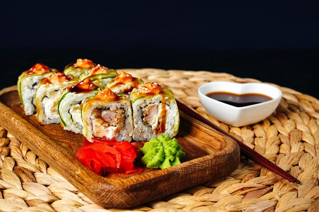 Japanese rolls with shrimp wrapped in cucumber with spicy sauce sushi close up High quality photo