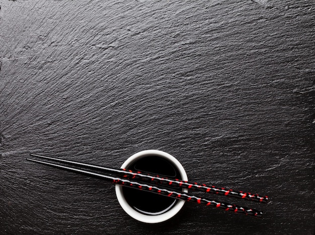 Japanese sushi chopsticks over soy sauce bowl