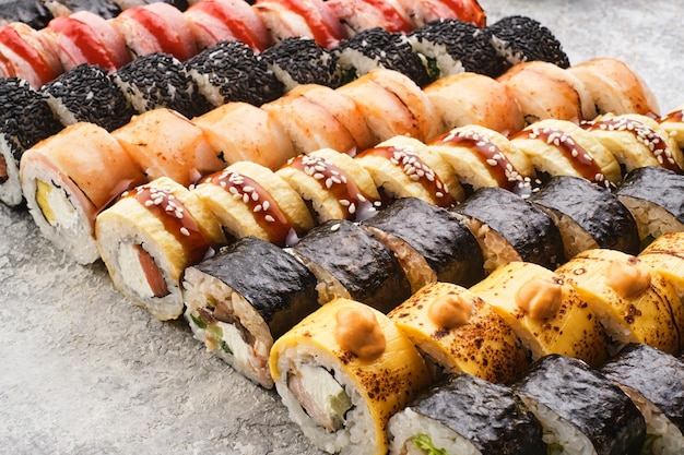 Japanese sushi food. Maki ands rolls with tuna, salmon, shrimp, crab and avocado. Assorted sushi.