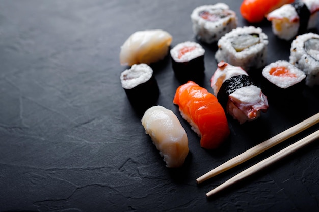 Japanese sushi food maki ands rolls with tuna salmon shrimp crab and avocado top view of assorted sushi