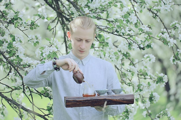 japanese tea ceremony in the spring garden, aroma cherry blossom sakura in asia