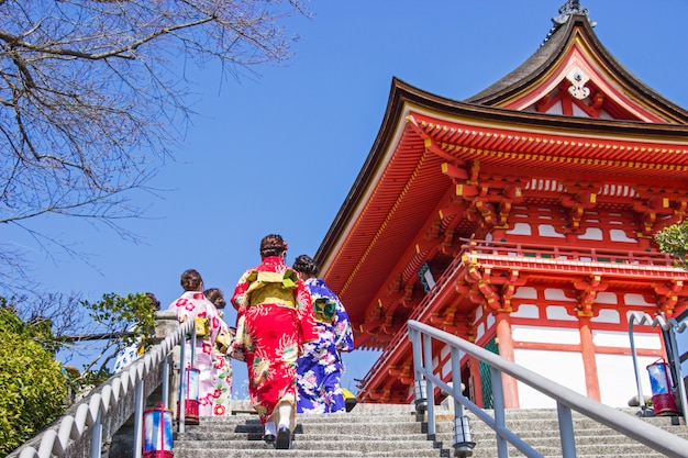 Japanese tourists and foreigners put on a dress yukata for visit the atmosphere inside the Kiyomizu-dera temple