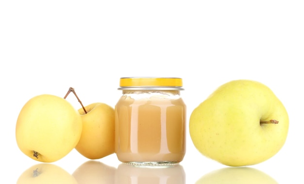 Jar of baby puree and apples isolated on white