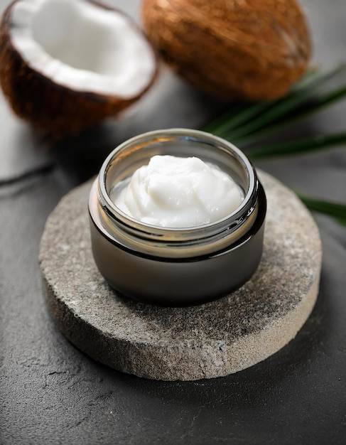 Photo jar of coconut body butter on round stone podium organic beauty product natural cosmetics