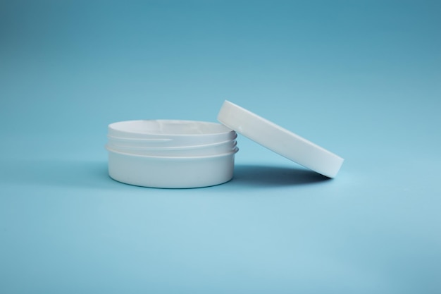 Jar of cream on a blue background beauty and body care industry