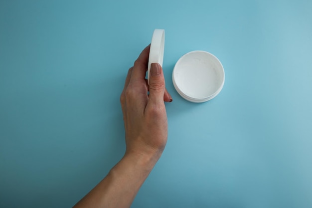 Jar of cream on a blue background beauty and body care industry