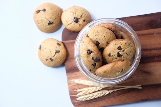 Jar full of chocolate chip cookies on white background