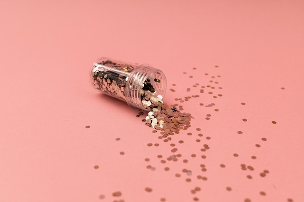 Jar of glitter on a pink background glitter for eyes and hands