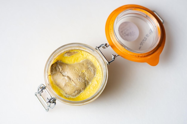 Jar of goose liver foie gras on a white background Liver in the shape of a heart