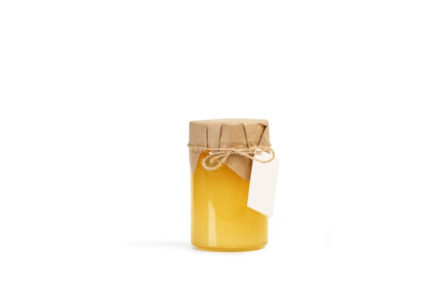 A jar of honey with a blank label on a white background with copy space