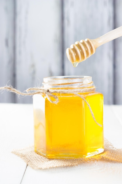 Jar of honey on wooden table