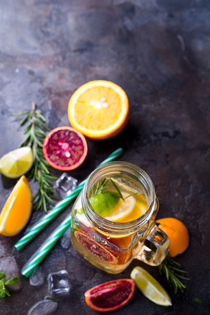 Jar of lemonade with citrus fruits