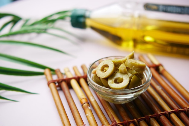 A jar of olive in a glass jar on table