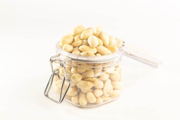 jar of peanuts on white background