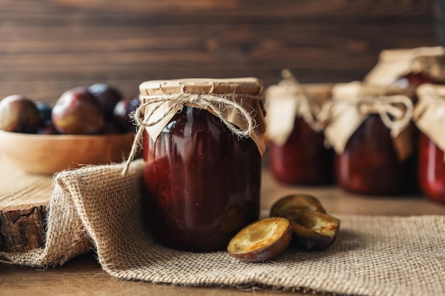 Jar of plum jam with craft decor