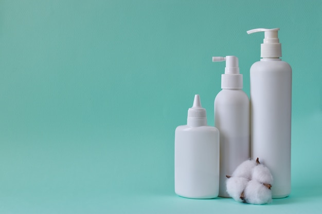 Jar with baby powder, bottle of talcum powder, liquid soap and shower gel, cotton isolated on a blue background. Body care. Spa Relax Baby hygiene.