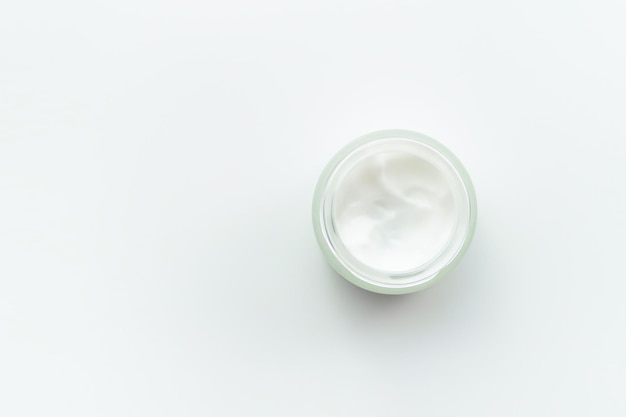 jar with cosmetic cream on a white background top view