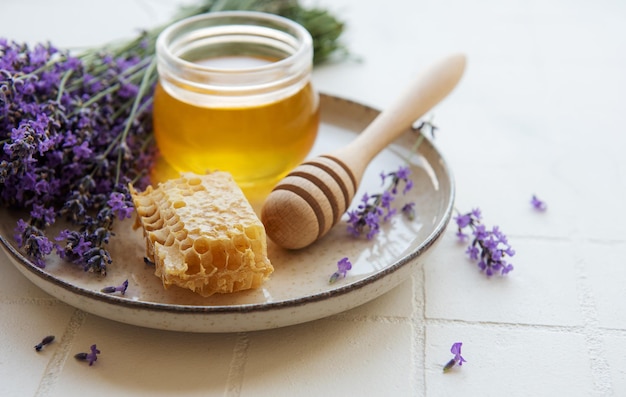 Jar with honey and fresh lavender flowers