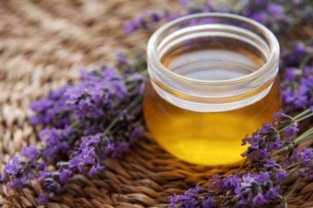 Jar with honey and fresh lavender flowers