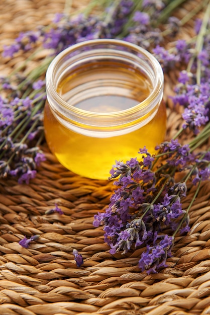 Jar with honey and fresh lavender flowers