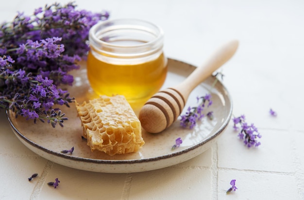 Jar with honey and fresh lavender flowers