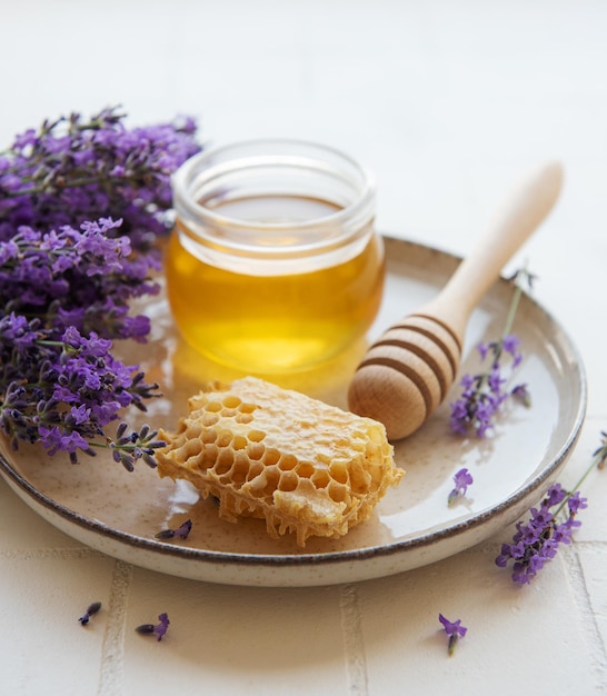 Jar with honey and fresh lavender flowers