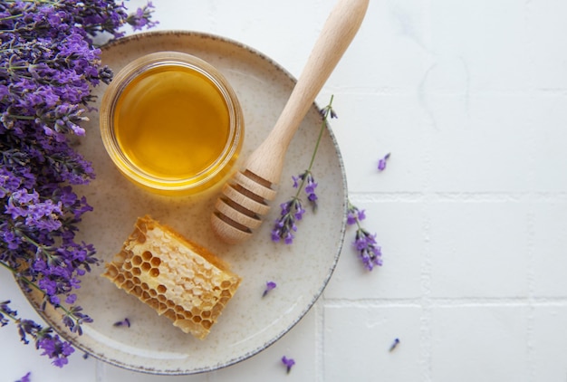 Jar with honey and fresh lavender flowers