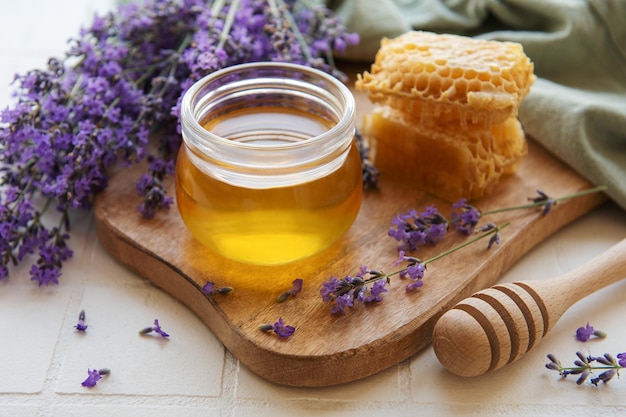 Jar with honey and fresh lavender flowers