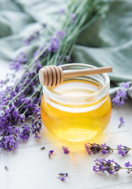 Jar with honey and fresh lavender flowers