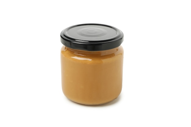 Jar with peanut butter isolated on white background