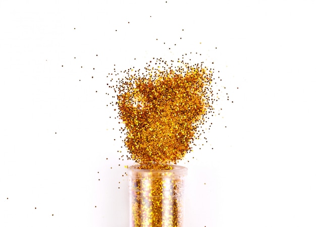 Jar with spilled gold glitter, shiny eyeshadows on white