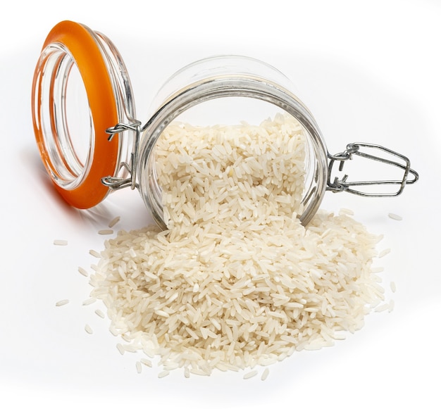 Jar with spilled raw and dry white rice