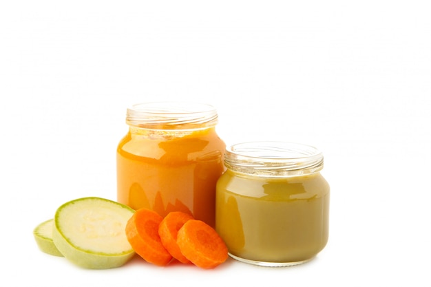 Jars of baby puree with carrots and banana isolated