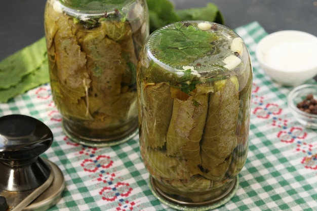 Jars of pickled cucumbers in grape leaves are turned upside down Canning cucumbers for the winter