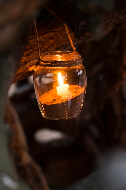 Jars with candles and sand decorations in nature