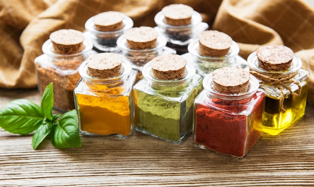 Jars with dried herbs, spices on the table