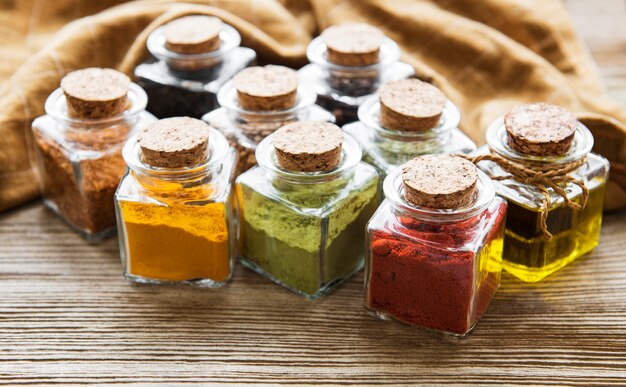 Jars with dried herbs, spices on the table